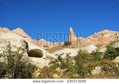 Cappadocia Landscape. Fairy Chimneys In Cappadocia In Red Rose Valley. Deep Blue Sky Over Fungous Fo