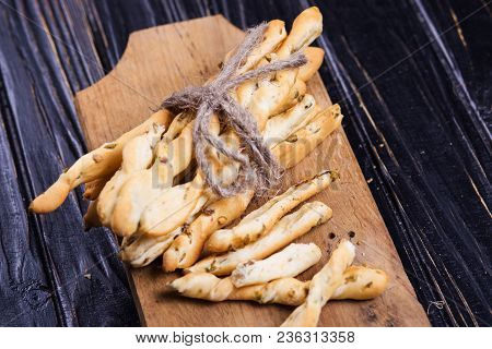 Crispy Grisini With Olive On Wooden Plate In Studio