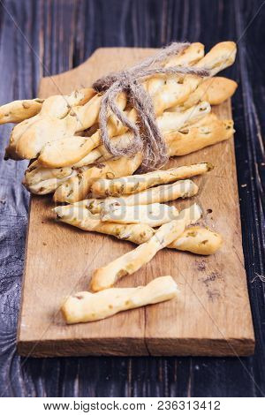 Crispy Grisini With Olive On Wooden Plate In Studio