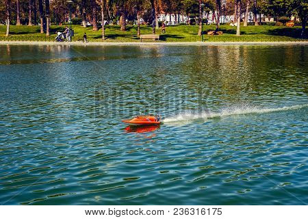 Red Remote Ship Toy On Lake, Close View
