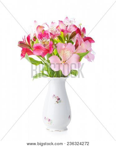 Bouquet of Alstroemeria flowers in  old  porcelain vase isolated on white background.