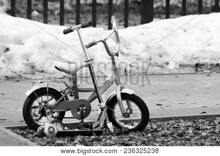 Children's Bike And Scooter In The Spring Park