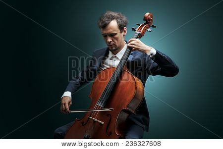 Lonely cellist composing on cello with nothing around