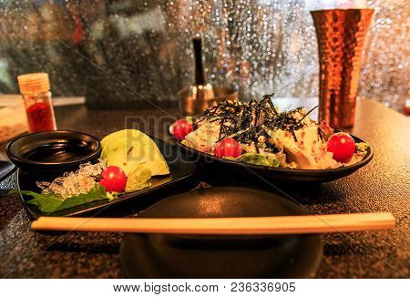 Avocado Sashimi With Wasabi And Soy Sauce Next To Tofu Salad On A Rainy Osaka Night
