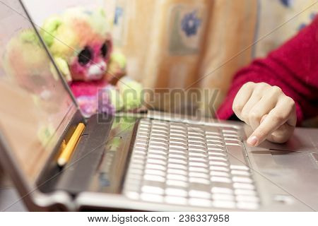 A Child Does Homework For A Laptop.