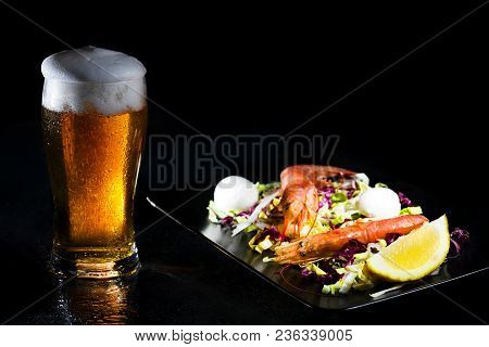 Sweated Glass Of Cold Light Beer And Salad With Argentine Red Shtimp. Pfoto On Dark Background. Copy