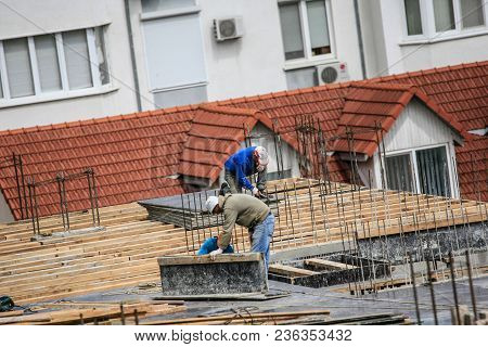 Builders That Works On The Construction Site With Hammer