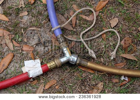 Three Prong Cord Outlet Plug On Dirt Grass