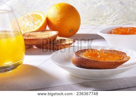 Morning Breakfast Set With Orange Jam On Bread Toast And Juice In Glass