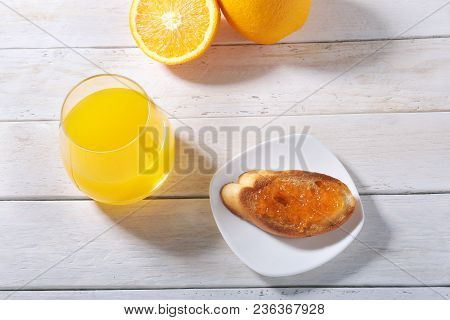 Morning Breakfast Set With Orange Jam On Bread Toast And Juice In Glass
