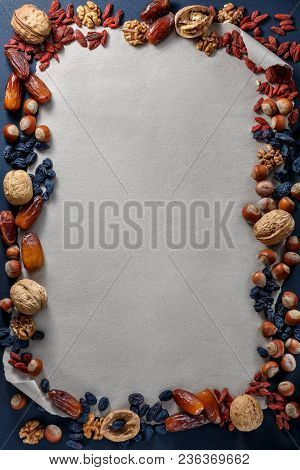 Several Pieces Of Halvah, Nuts And Dried Fruit Food Frame On Paper Background With Copy Space For Te