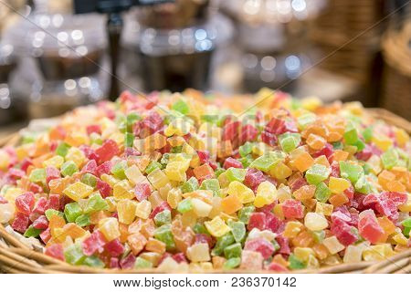Fresh Multi-colored Candied Fruits In A Wicker Basket.