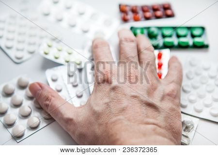 Hand And Pills On The Table At The Home Closeup