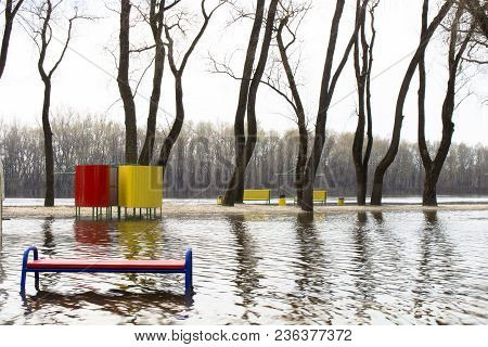 The River Spilled From Its Banks. In Water - Beach, Benches, Cabanas, A Road. It Happens Every Sprin