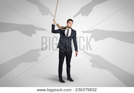 Young businessman trying to suicide with pointing hands concept