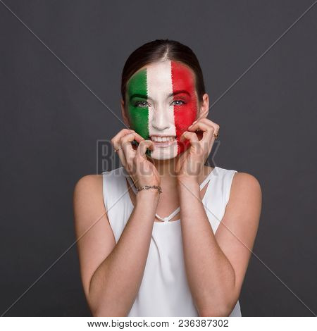 Portrait Of Happy Woman With The Flag Of Italy Painted On His Face. Football Or Soccer Team Fan, Spo
