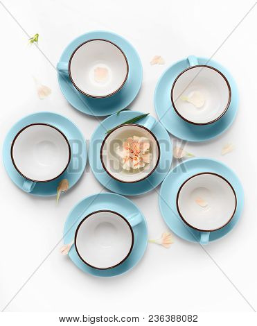Clean Coffee Or Tea Set. Plenty Of Elegant Porcelain Light Blue Cups And Saucers At White Isolated B