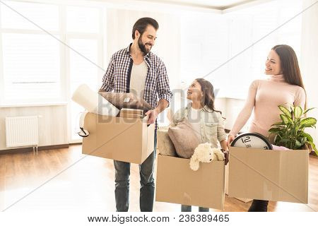 Nice Picture Of Two Adults And One Child. Girls Are Looking At The Young Man And Smilin To Them Whil