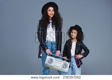 Mother And Daughter With Retro Boombox Isolated On Grey