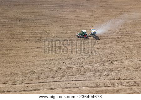 Tractor Fertilizing Field, Aerial View. Tractor Spreading Artificial Fertilizers.