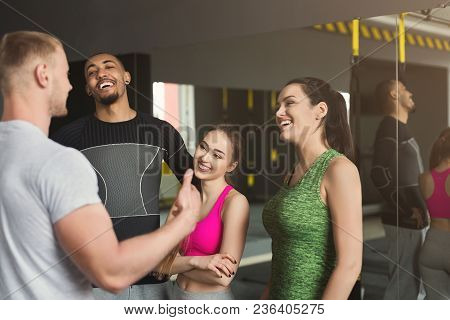 Group Of Young Sporty Smiling Multiethnic People Having Fun, Talking After Workout, Friends Having R