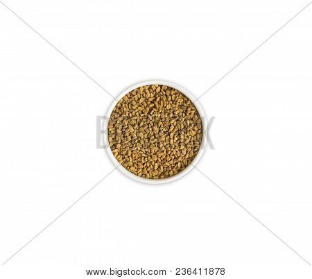 Fenugreek With Seeds In A Bowl. Fenugreek Seeds Isolated On White Background. Top View.