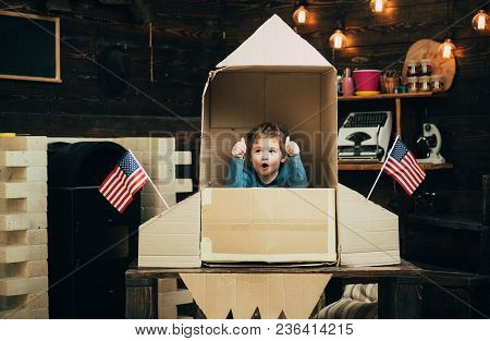 Boy Play With Rocket, Cosmonaut Sit In Usa Rocket Made Out Of Cardboard Box. Kid Excited Sit In Card