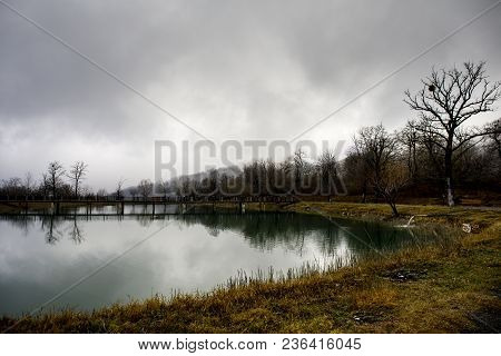 Amazing Landscape Of Bridge Reflect On Surface Water Of Lake, Fog Evaporate From Pond Make Romantic