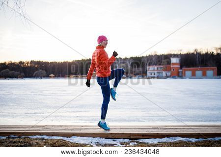 Potrtait Of Young Athlete Blonde At Morning Exercises In Winter Park