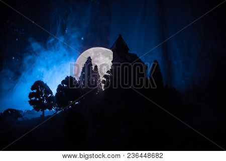 Old House With A Ghost In The Forest At Night Or Abandoned Haunted Horror House In Fog. Old Mystic B