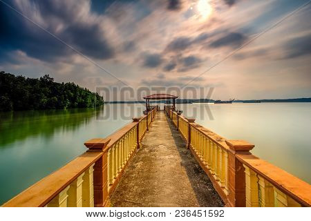 Beautiful Long Exposure Sunrise Shot At Jetty. Image Contain Certain Grain Or Noise And Soft Focus W