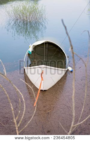 Lonely Empty White Fisherman Boat On The Shore Of Lake Skadar In Virpazar, Montenegro
