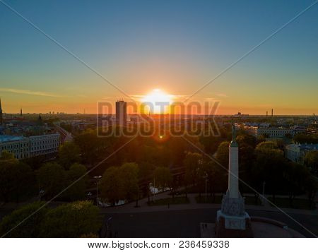 Amazing Aerial Sunset View Over Riga City In Latvia. Statue Of Liberty In The Middle Of The City - M