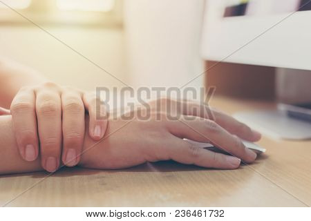 Hand Of A Businessman With A Wrist Injury Of His Own Working A Computer. Office Syndrome Concept
