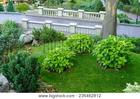 Decorative Stone Bridge With Balusters On A Slope In Landscape Design