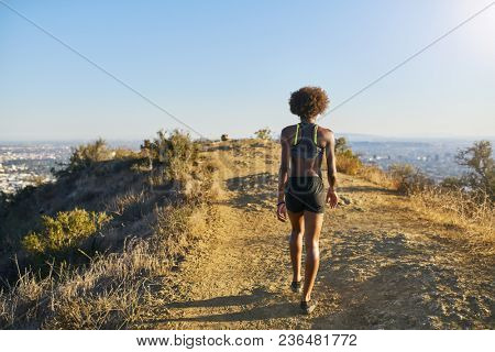fit african american woman walking at the top of runyon canyon in los angeles