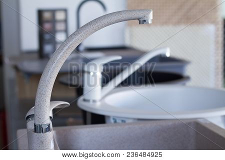 Modern Kitchen And Bathroom Water Faucets In The Store. Selective Focus. There Is Free Space For Tex