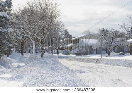 Heavy Winter Snow Fall In Canadian Residential Area - Snow Covered Streets On A Bright Sunny Day