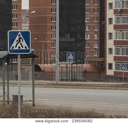 Road signs on the background of buildings. Pedestrian road sign. Urban landscape. Urban grunge. Grunge style.