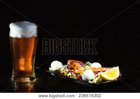 Glass Of Light Beer And Salad With Argentine Red Shtimp. Photo On Dark Background. Copy Space
