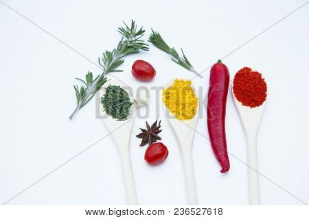 Cooking Hot Spicy Food Concept. Dry Spices And Herbs In Wooden Spoons, Fresh Herbs, Chili Pepper And