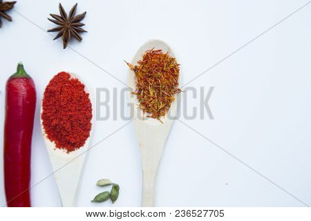 Cooking Hot Spicy Food Concept. Dry Spices And Herbs In Wooden Spoons And Chili Pepper, White Backgr