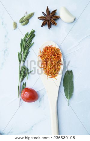 Cooking Hot Spicy Food Concept. Dry Spices In Wooden Spoon And Fresh Herbs, White Marble Background,