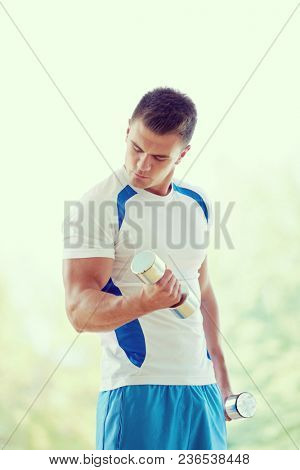 young man in fintess sport club exercise with weights and relaxing