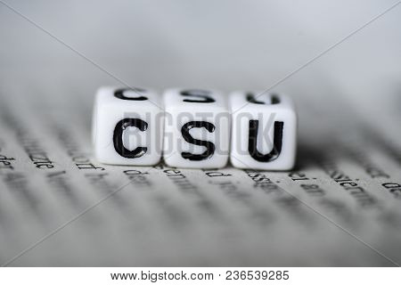 Word Csu Formed By Wood Alphabet Blocks On Newspaper German Party Politics Closeup