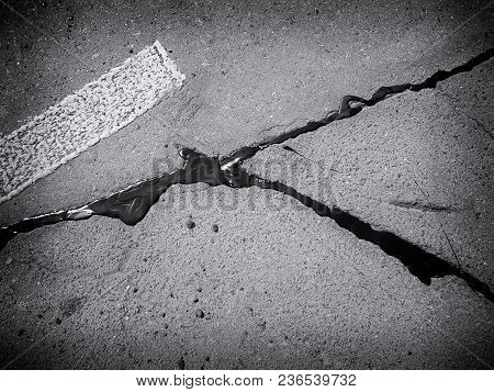 Autumn Day. Asphalt Road, The Crack Is Resected With Resin. Photographed In Ukraine, Kiev. Black And