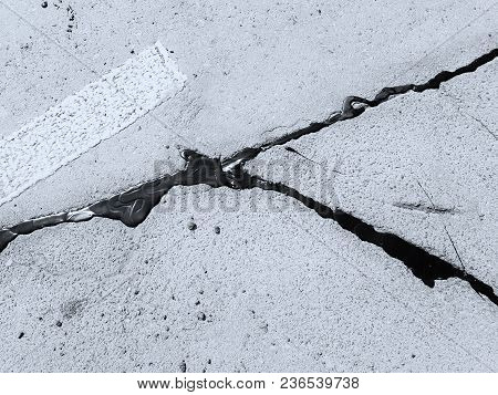 Summer Day. Asphalt Road, The Crack Is Resected With Resin. Photographed In Ukraine, Kiev. Black And