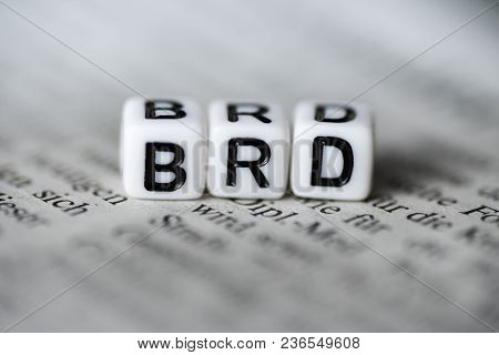 German Word Brd Formed By Wood Alphabet Blocks On Newspaper Closeup