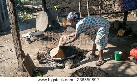 Omo, Ethiopia - September 2017: Ethiopean Woman Cooking Ethiopean Bread Called Injera