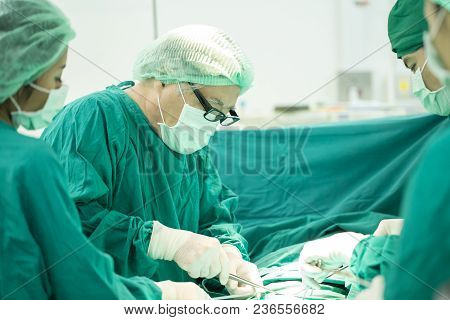 The Surgery Team Working Together At The Operating Room In The Hospital.